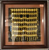 A framed and mounted gilt metal face veil of proba