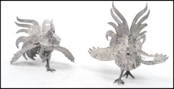 A 20th century pair of good silver plate fighting cocks - cockerel with eyes, both in differing