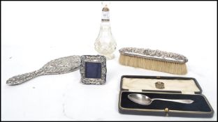 A group of hallmarked silver items to include a Victorian silver brush having a Art Nouveau scrolled