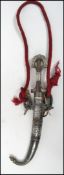 A 19th century Islamic Jambiya decorative dagger having a silver metal decorated shaped handle and