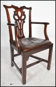 A 19th century mahogany and leather Chippendale office desk chair. Raised on squared legs with h-