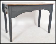 A 1920's air ministry style wooden school desk having a drop leaf to one side raised on painted