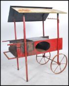 An unusual mid century Chestnut Roaster cart. Of cast and wrought metal construction having