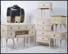 A Louis XV style cream bedroom suite to include a dressing table with a tryptych mirror, bedside