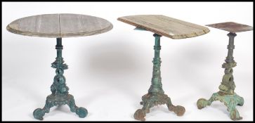 A series of 3 cast iron garden tables with remnants of tops. Each with tripod bases having carp /