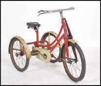 A vintage early 20th century childs tricycle - trike in red and white two tone colourway, dunlop