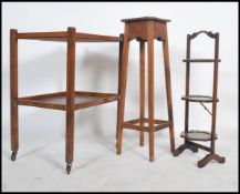A 1930's oak torchere plant stand of pedestal form together with a 1930's metamorphic cake stand