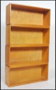 A set of four stacking 20th century modular beech and dovetail jointed bookshelf / bookcase units