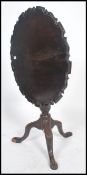 A 19th century Georgian mahogany pie crust edge tilt top tripod wine table. Raised on splayed legs