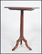 A 19th century oak ecclesiastical tripod table. Of oak construction, hexagonal column with chamfered
