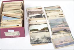 A shoe box containing a collection of approximately 600 - 700 postcards dating from the early 20th