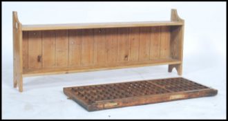 A vintage Industrial 20th century pine seed tray together with a country pine hanging shelf of
