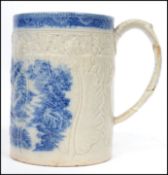 An 18th century English factory Pearlware tankard cup decorated in a blue and white pattern with