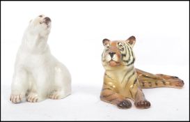 A Branksome china polar bear figurine together with a Midwinter figurine of a tiger. Both with