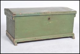 A Victorian painted country pine blanket box of shaped form with stub feet having a hinged top.