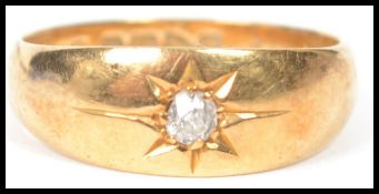 An 18ct gold and diamond ladies single stone ring having approx 10pnt diamond in star setting. The