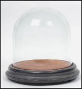 A Victorian glass dome and ebonised plinth stand being ideal for taxidermy or clock cover.