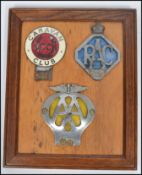 A group of three vintage 20th century motoring related car badges all mounted to a board set