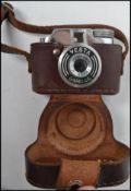 A vintage Vesta GRC Ginrei F-20 mm miniature camera complete with leather case. In the case measures