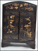 A mid century Chinese chinoserie decorated table top pedestal jewellery cabinet with double doors