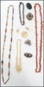 A collection of vintage costume jewellery to include an agate lozenge necklace a jet mourning