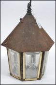 A good rustic Arts & Crafts type porch lantern of hexagonal form with thick bevelled glass panels