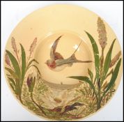 A 19th  century aesthetic movement hand painted decorative wall charger, the centre of the bowl
