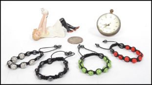 A ladies contemporary bone bangle together with a pocket ball clock, ceramic figurine and a bracelet