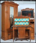 A late 19th century Art Nouveau Satin Walnut three piece bedroom suite, comprising a wardrobe with