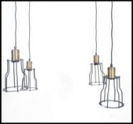 A group of four vintage industrial style pedant ceiling cage lights, black wire work cages with