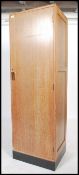 A vintage early to mid 20th century limed oak bachelors wardrobe of slim proportions having a single