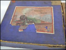 A collection of 1950s Hornby O Gauge Railway toy model trains to include a clockwork locomotive in a