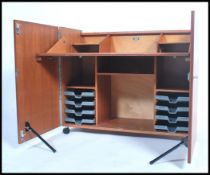 A 1970's retro teak wood office Industrial cube desk - filing cabinet having twin doors, raised on