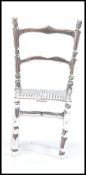 An unusual silver miniature ornament in the form of an antique chair, possibly dolls house. Total