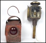 A brass coach lamp with conversion to electric together with a red painted railways lamp. Highest