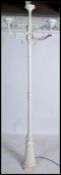 A Victorian style garden standard lamp in the form of a Victorian street lamp raised on a