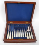 A 12 person mahogany canteen of cutlery having a inset brass armorial plaque.the hinged lid