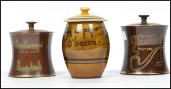 A group of three early 20th century pipe tobacco advertising point of sale ceramic storage jars, one