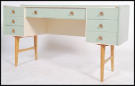 A vintage 20th century up cycled two tone painted twin pedestal knee-hole desk having an arrangement