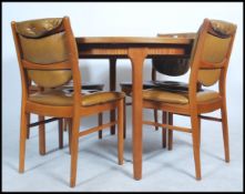 A 1970's retro teak wood dining table and matching 4 dining chairs by McIntosh of Kirkcaldy. The