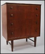 A good Danish influenced 1970's retro teak chest of drawers being raised on tapering legs with an