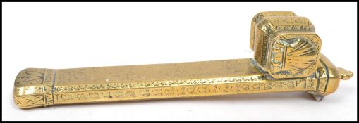 A 19th century brass travelling scholars calligraphy pen and inkwell set having a chased