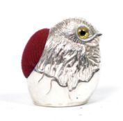 A silver pin cushion in the form of a chick having baize cushion and in the manner of Adie and