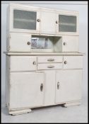 A 1930's Art Deco painted French kitchen dresser cabinet. The base with shaped bracket feet