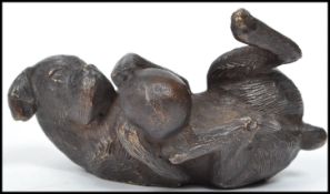 An early 20th century bronze? paperweight in the form of a boxer dog playing with ball, originally a