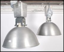 A pair of large industrial vintage mid 20th century aluminium ceiling lights of domed circular