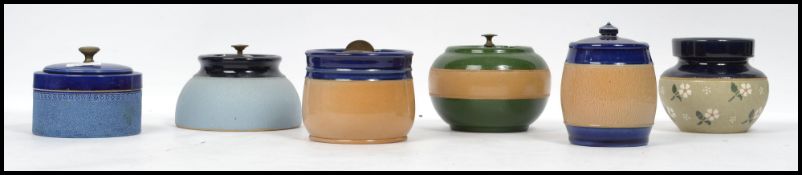 A group of vintage 20th century ceramic tobacco jars to include Royal Doulton examples, each with