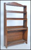 A 1920's solid oak open window waterfall bookcase. Of upright form having fixed shelves with