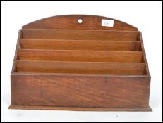 An Edwardian desk top stationary tidy together with two black forest style ink pots one in the