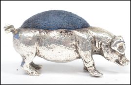 A vintage 20th century silver hallmarked pin cushion in the form of a pig bearing hallmarks for